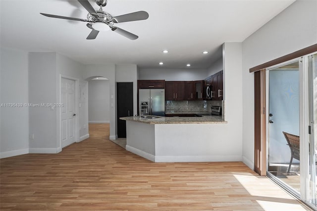 5761 NW 115th Ct Unit 105, Doral, FL 33178 - kitchen with stainless steel appliances, arched walkways, light wood finished floors, ceiling fan, and dark brown cabinetry
