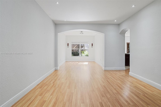 5761 NW 115th Ct Unit 105, Doral, FL 33178 - spare room with arched walkways, light wood finished floors, and recessed lighting
