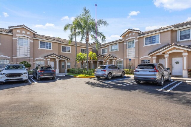 5761 NW 115th Ct Unit 105, Doral, FL 33178 - multi unit property featuring uncovered parking, stucco siding, and a tile roof