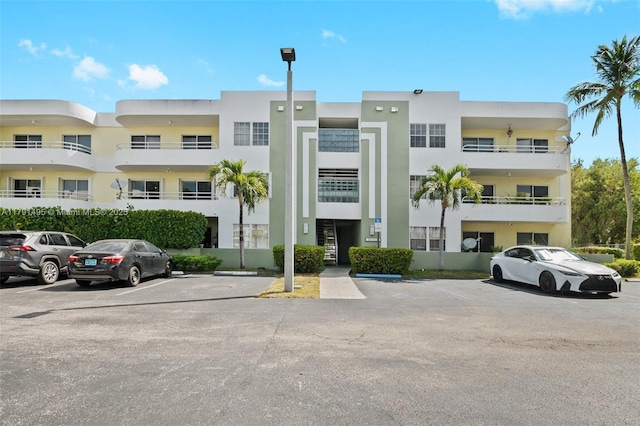 view of building exterior featuring uncovered parking