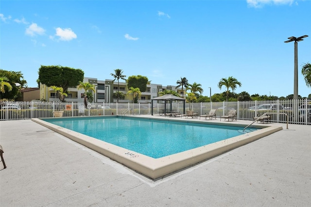 pool featuring a patio area and fence