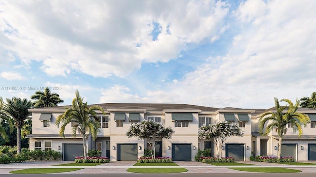 multi unit property featuring an attached garage and driveway