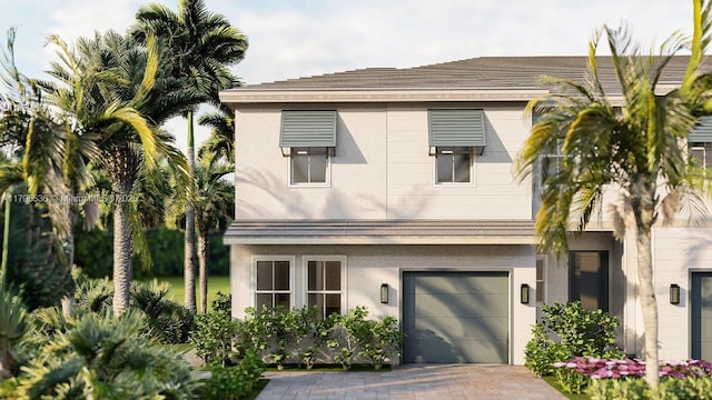 view of front of home featuring a garage, stucco siding, and driveway