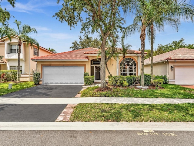 102 Gables Blvd, Weston, FL 33326 - mediterranean / spanish house with stucco siding, a tile roof, asphalt driveway, and a garage