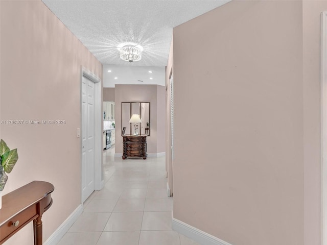 102 Gables Blvd, Weston, FL 33326 - corridor with a chandelier, light tile patterned flooring, and baseboards