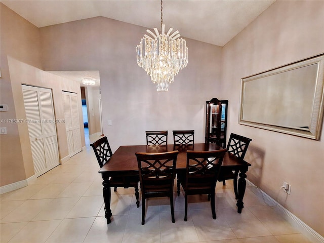 dining space with light tile patterned floors, high vaulted ceiling, baseboards, and an inviting chandelier