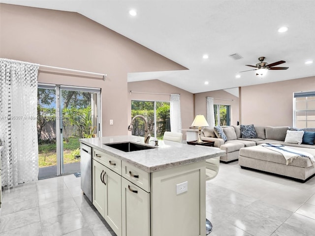 102 Gables Blvd, Weston, FL 33326 - kitchen featuring a sink, lofted ceiling, stainless steel dishwasher, plenty of natural light, and an island with sink
