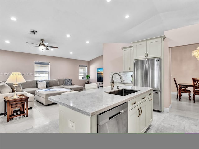 102 Gables Blvd, Weston, FL 33326 - kitchen featuring stainless steel appliances, a sink, a kitchen island with sink, light stone countertops, and recessed lighting