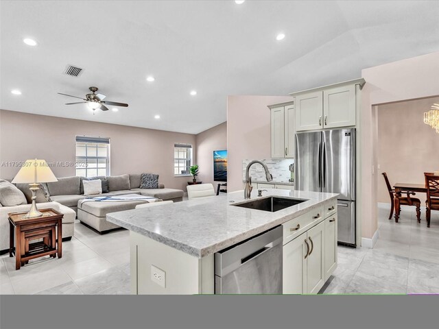 102 Gables Blvd, Weston, FL 33326 - kitchen featuring appliances with stainless steel finishes, a kitchen island with sink, light stone countertops, open floor plan, and recessed lighting