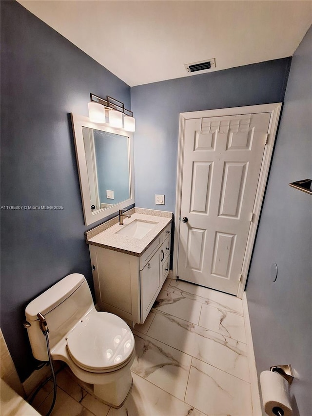 bathroom with vanity, visible vents, toilet, and marble finish floor