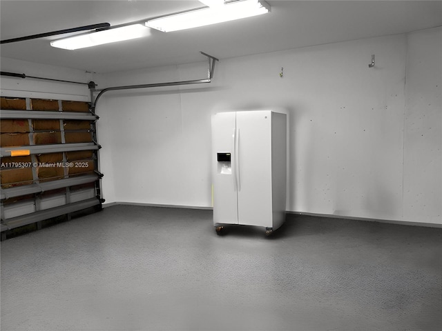 garage featuring white fridge with ice dispenser