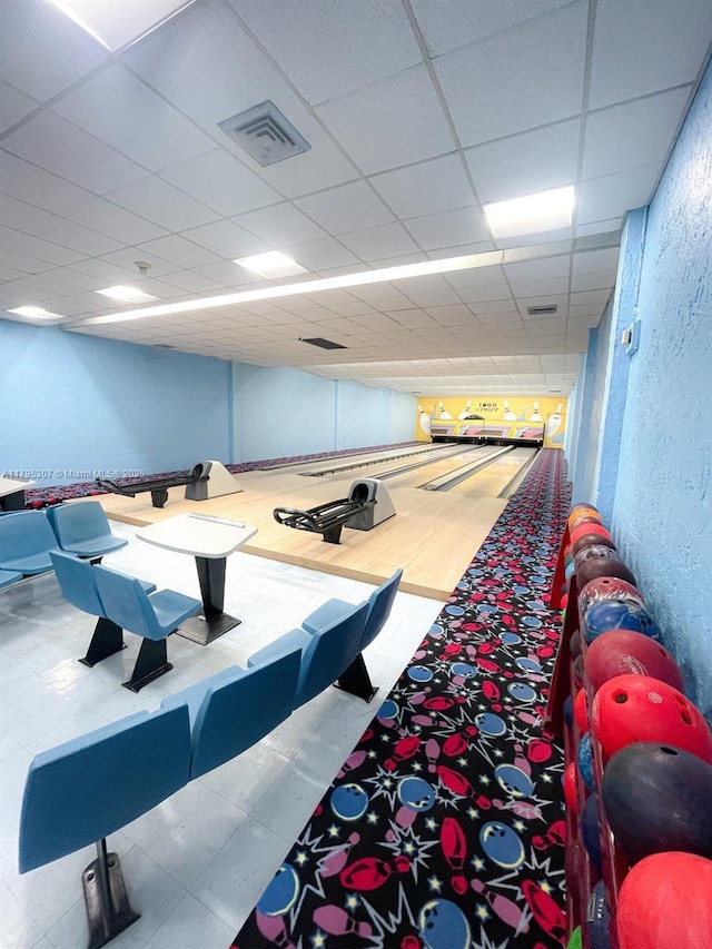 playroom featuring a textured wall, a bowling alley, and visible vents