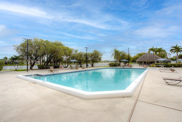 pool with a patio and a gazebo