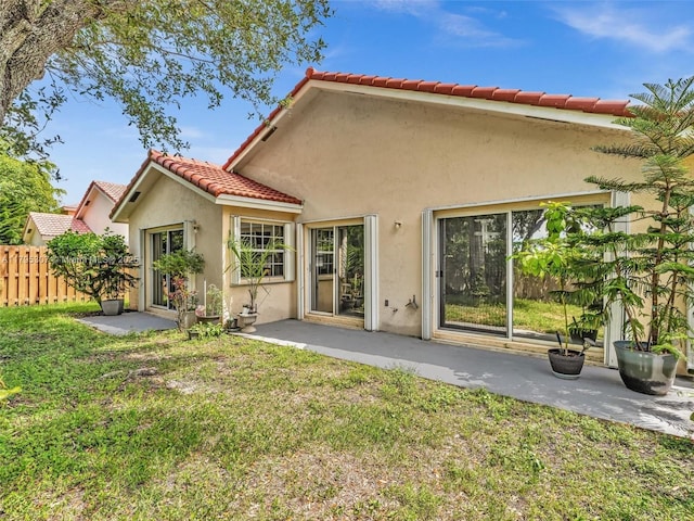 102 Gables Blvd, Weston, FL 33326 - back of property with stucco siding, a tiled roof, and a patio