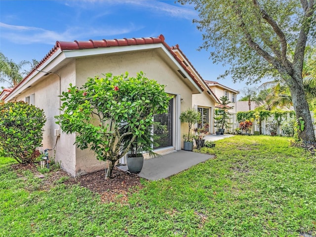 102 Gables Blvd, Weston, FL 33326 - rear view of property featuring stucco siding, a tiled roof, and a patio