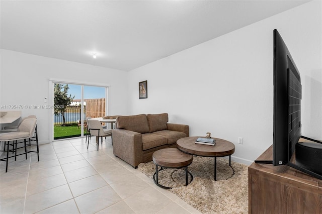 living area with baseboards and light tile patterned floors