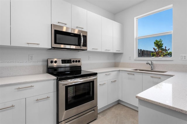 kitchen featuring a sink, white cabinets, and stainless steel appliances