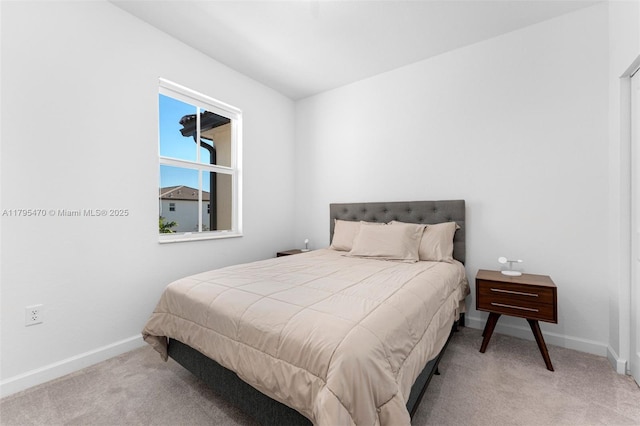bedroom with baseboards and carpet