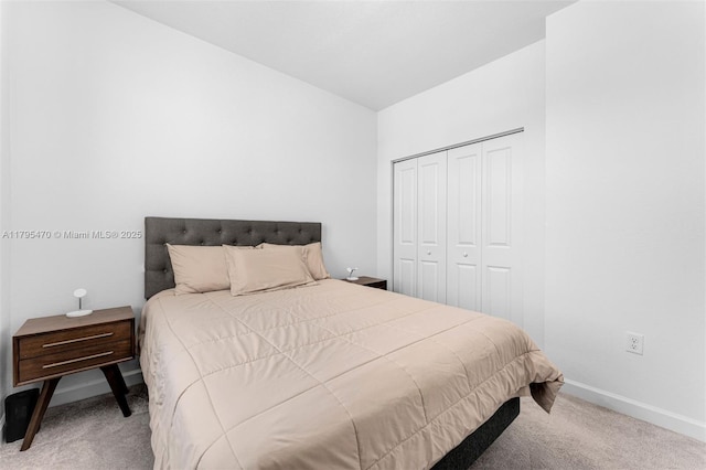 carpeted bedroom with baseboards and a closet