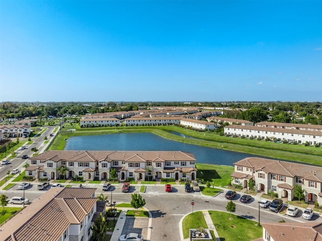 birds eye view of property featuring a water view and a residential view