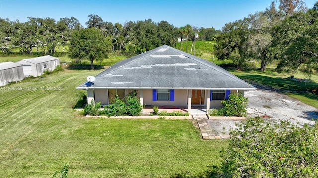exterior space with covered porch and a front lawn