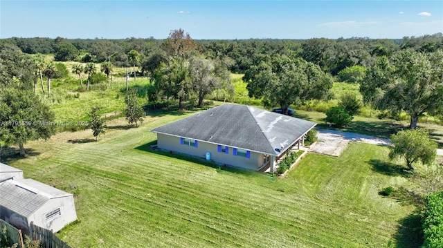birds eye view of property featuring a wooded view
