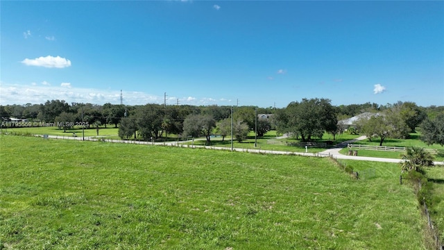 view of home's community featuring a yard and a rural view