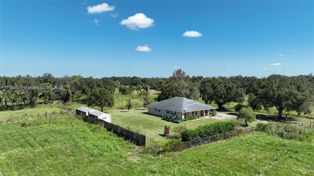 aerial view featuring a wooded view and a rural view