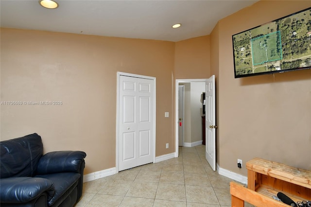 living area with light tile patterned floors, baseboards, and recessed lighting