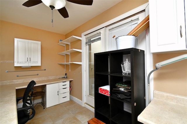 office space featuring light tile patterned flooring, baseboards, and a ceiling fan