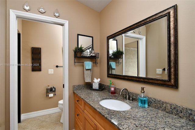 bathroom featuring tile patterned floors, toilet, baseboards, and vanity
