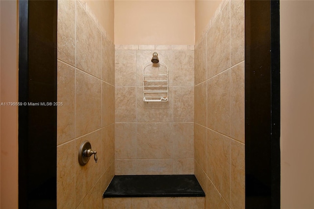 full bath with a tile shower