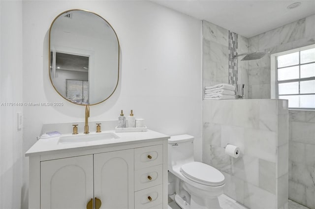 full bathroom with a marble finish shower, vanity, and toilet