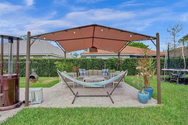 view of patio / terrace with a trampoline and fence