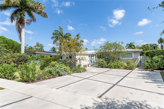 single story home featuring stucco siding and fence