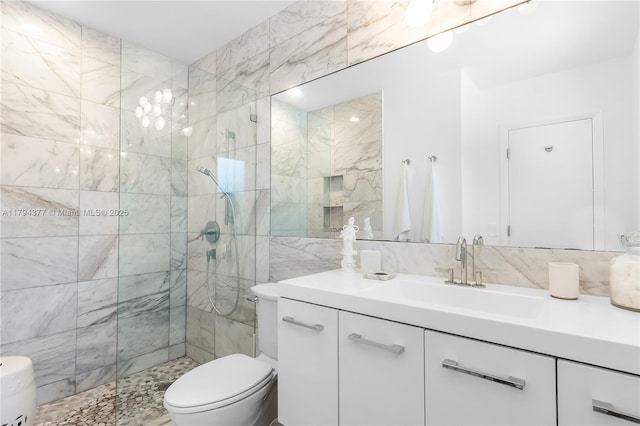 full bathroom with vanity, tile walls, walk in shower, and toilet