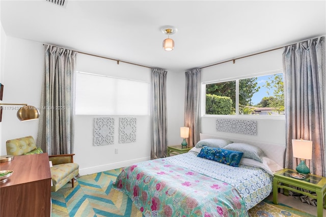 bedroom with baseboards and visible vents