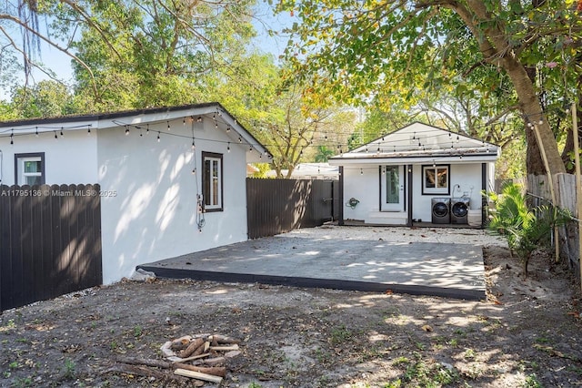 exterior space with a fenced backyard, a patio area, stucco siding, and an outbuilding