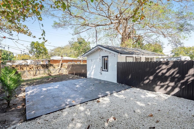 view of outbuilding featuring fence
