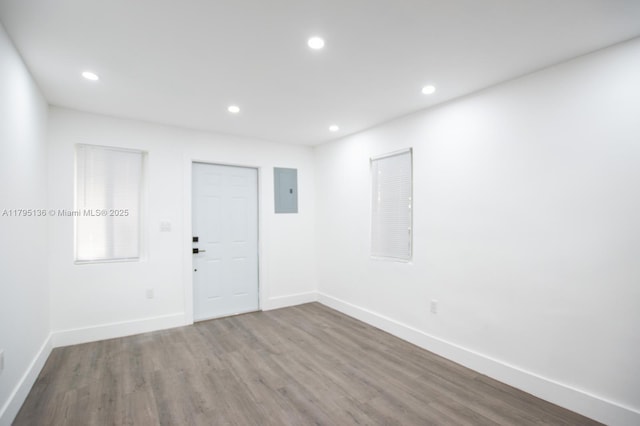 unfurnished room featuring baseboards, recessed lighting, and wood finished floors