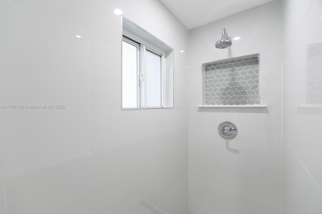 full bathroom with tiled shower