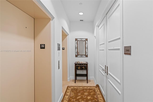 hallway featuring recessed lighting, elevator, and visible vents