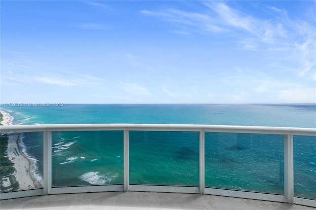 balcony with a view of the beach and a water view