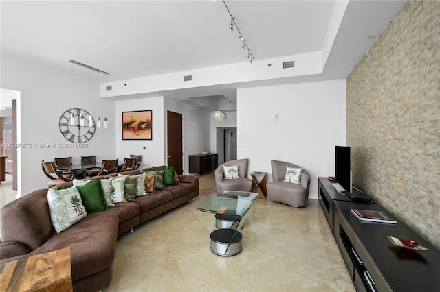 living room with visible vents and rail lighting