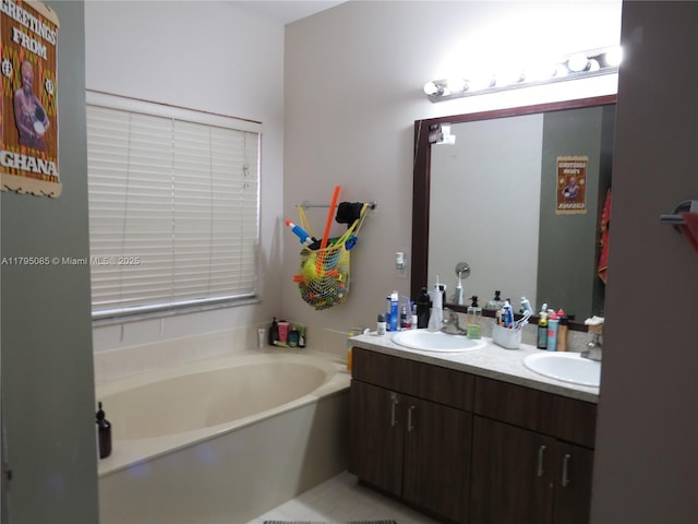 full bath with a garden tub, a sink, and double vanity