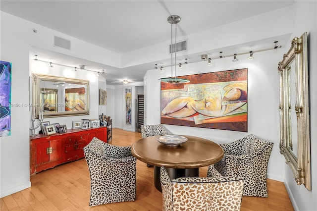 dining space featuring track lighting, baseboards, light wood-type flooring, and visible vents