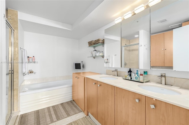 full bathroom with a sink, a stall shower, a garden tub, and visible vents