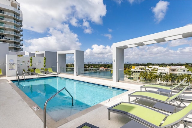 pool with a patio and a water view