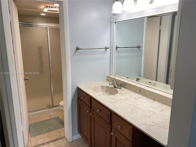 full bath featuring vanity, toilet, tile patterned flooring, and a stall shower