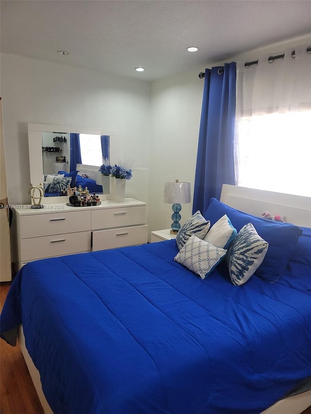 bedroom with wood finished floors and recessed lighting
